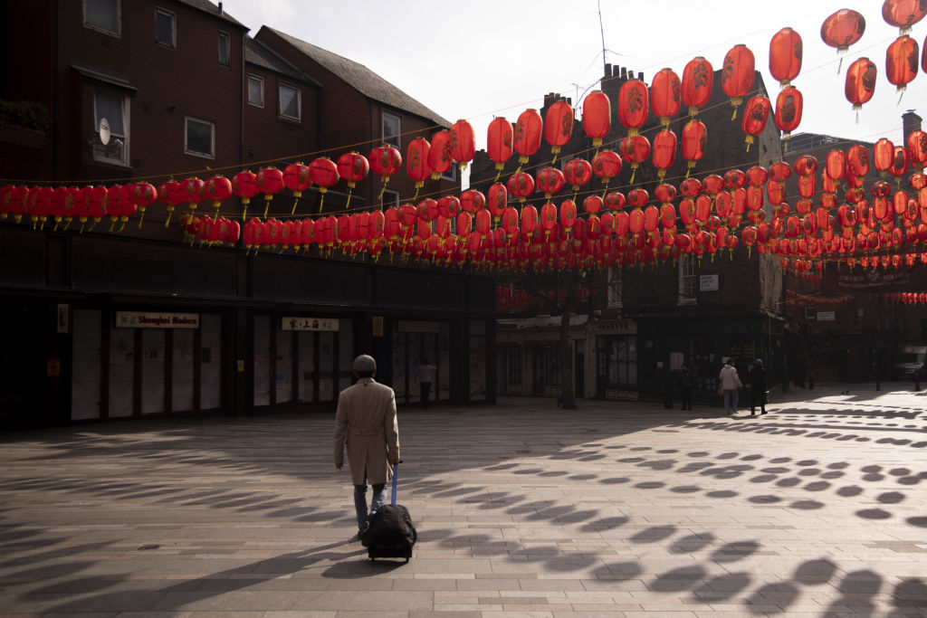 Man walking through deserted Chinatown in London