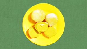 a yellow plate holding mochi ice cream from the brand my/mochi