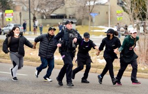 Police, King Soopers employees and customers run down Table Mesa Drive in Boulder after reports of shots fired inside on Monday, March 22, 2021.