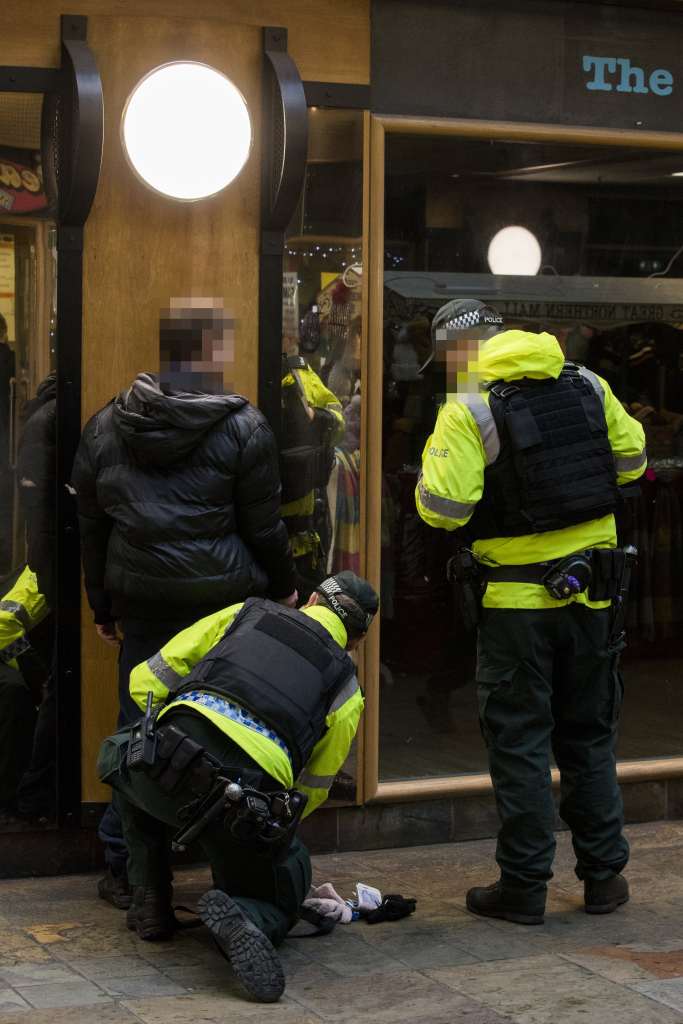 ​PSNI officers at Belfast Europa Buscentre in Northern Ireland performing a stop and search during a new police patrol to spot suspicious activity. Photo by Liam McBurney/PA Images via Getty Images