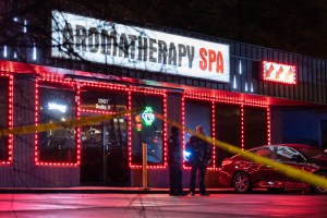 Law enforcement personnel are seen outside a massage business where a person was shot and killed on March 16, 2021, in Atlanta, Georgia.