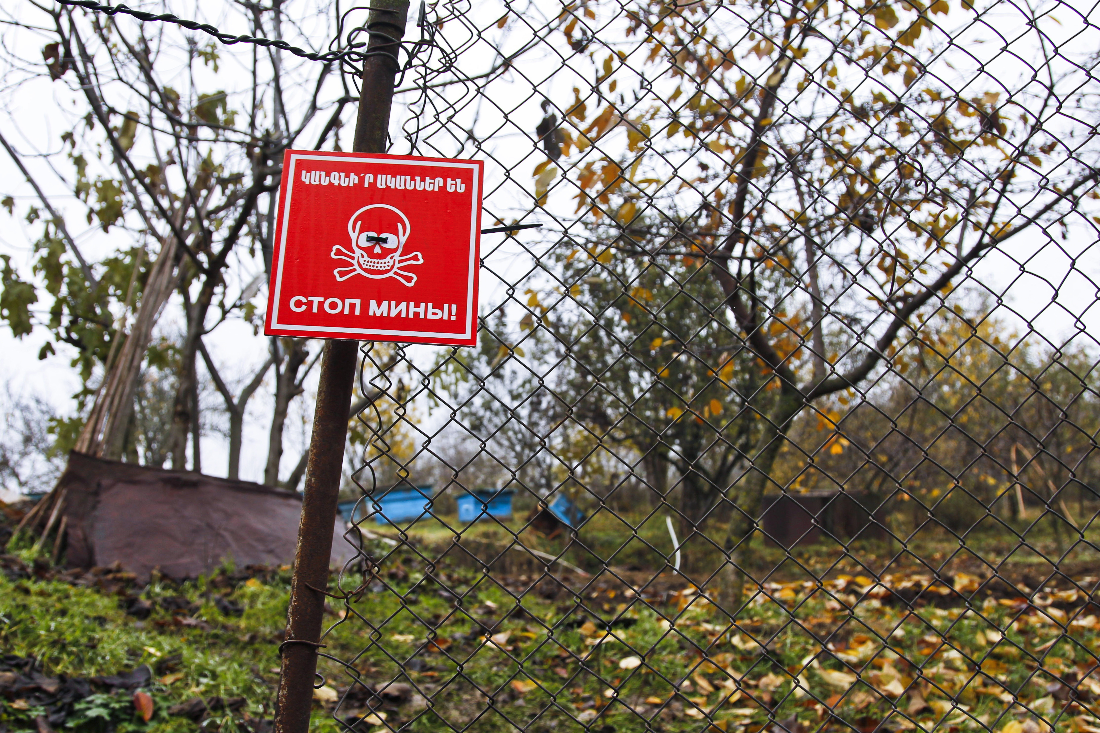 A sign warns of the presence of unexploded cluster submunitions in the village of Kaghartsi