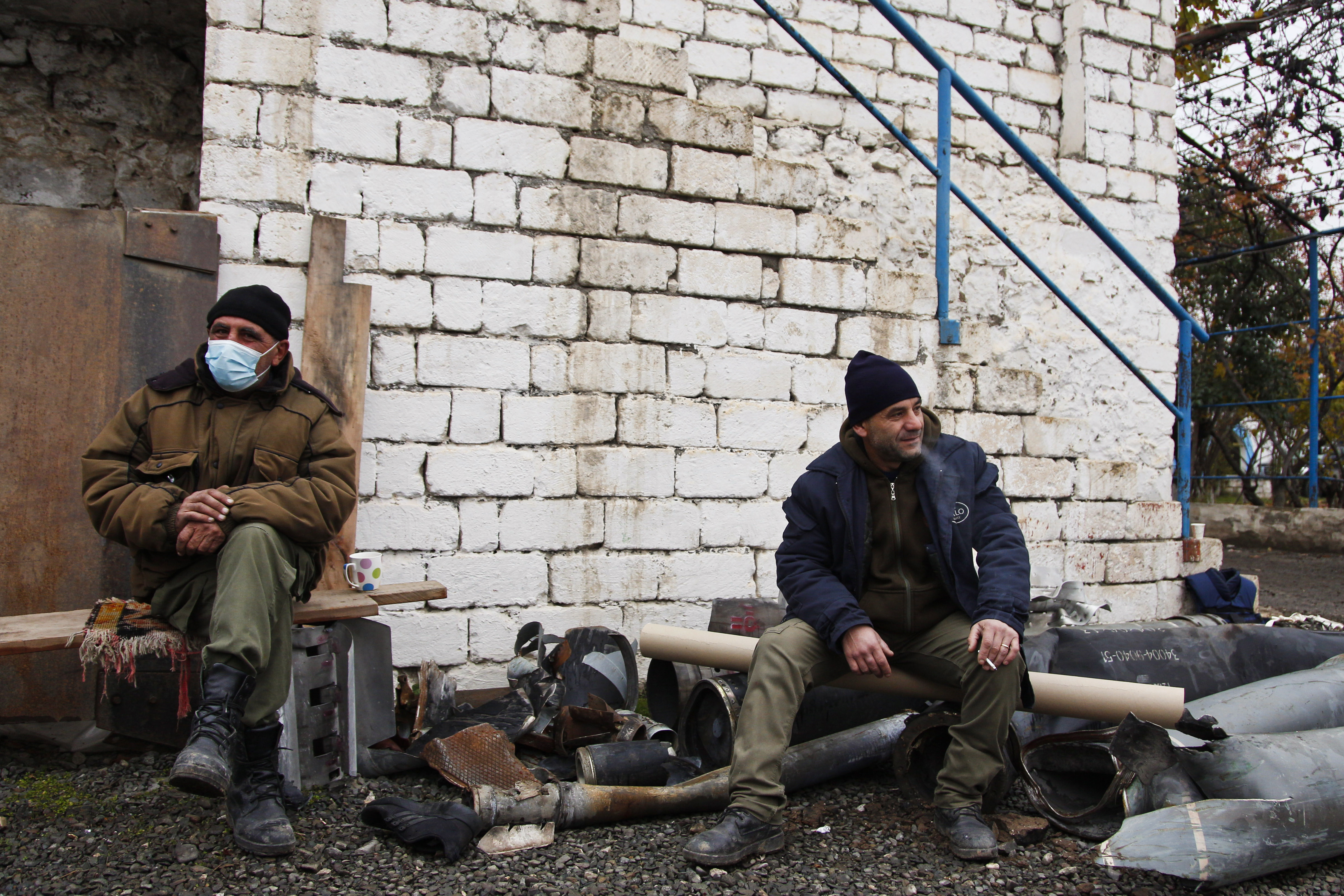 Sitting on spent rockets casings, deminers from the HALO Trust await to be deployed from their base in Stepanakert