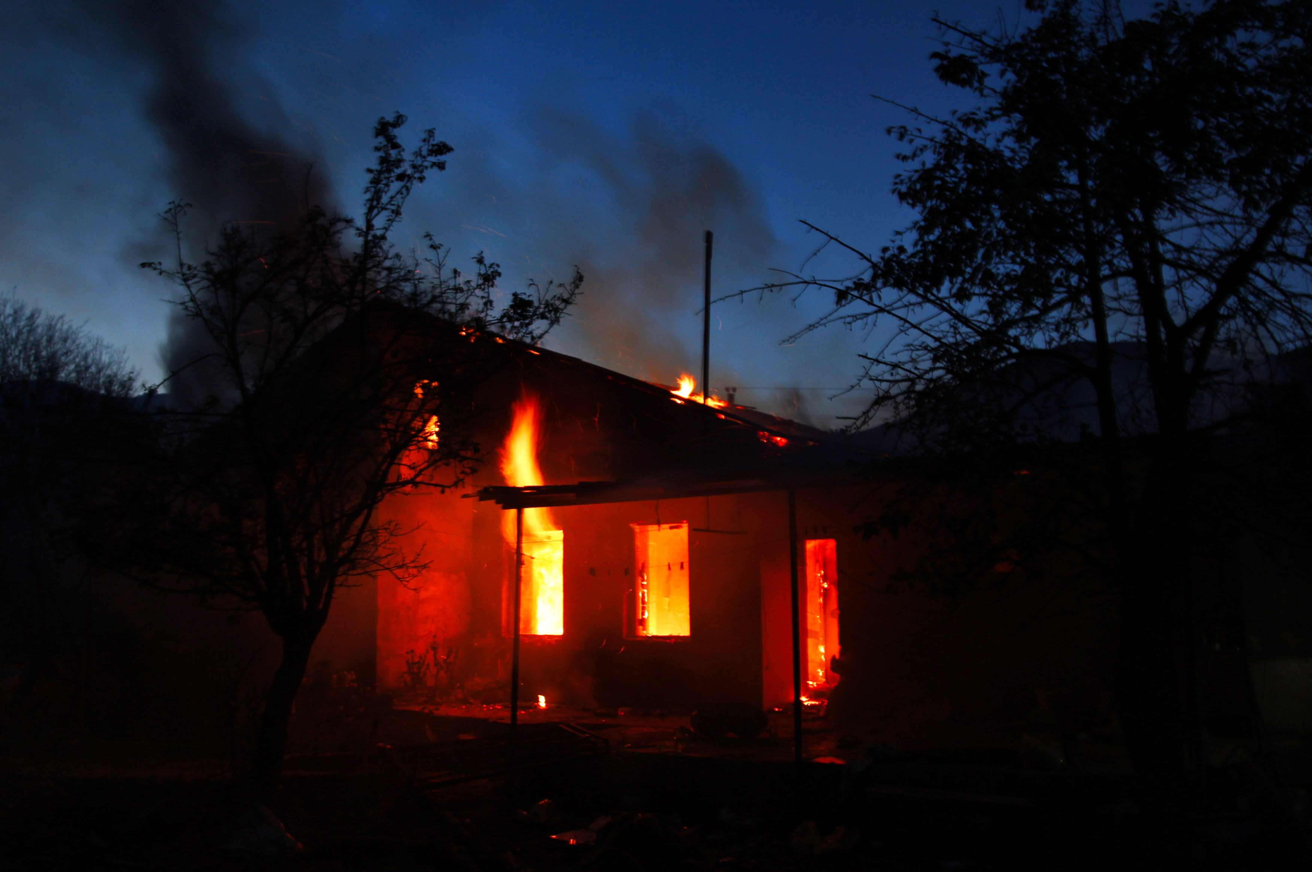 A home is set on fire in Armenian-held Kalbajar to deny incoming Azeris use of it ahead of the district's transfer to Azerbaijan's control