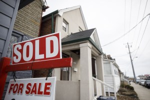 A "Sold" sign in front of a home in the York neighborhood of Toronto, Ontario, Canada, on Thursday, March 11, 2021.