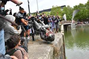 Protesters throw statue of Edward Colston into Bristol harbour during a Black Lives Matter protest rally, in memory of George Floyd. Photo by Ben Birchall/PA Images via Getty Images