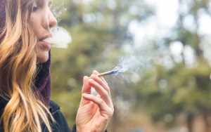 Woman Smoking Marijuana Joint Outdoors