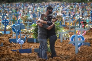 Relatives of a deceased person mourn during a mass burial of coronavirus  victims at the Parque Taruma cemetery on May 19, 2020 in Manaus, Brazil.