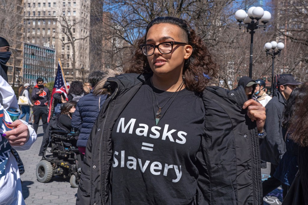 A protester wears a T-shirt saying "masks = slavery" in Union Square at a "Freedom Rally" in support of anti-mask and anti-vaccine. (Photo by Ron Adar / SOPA Images/Sipa USA)(Sipa via AP Images)