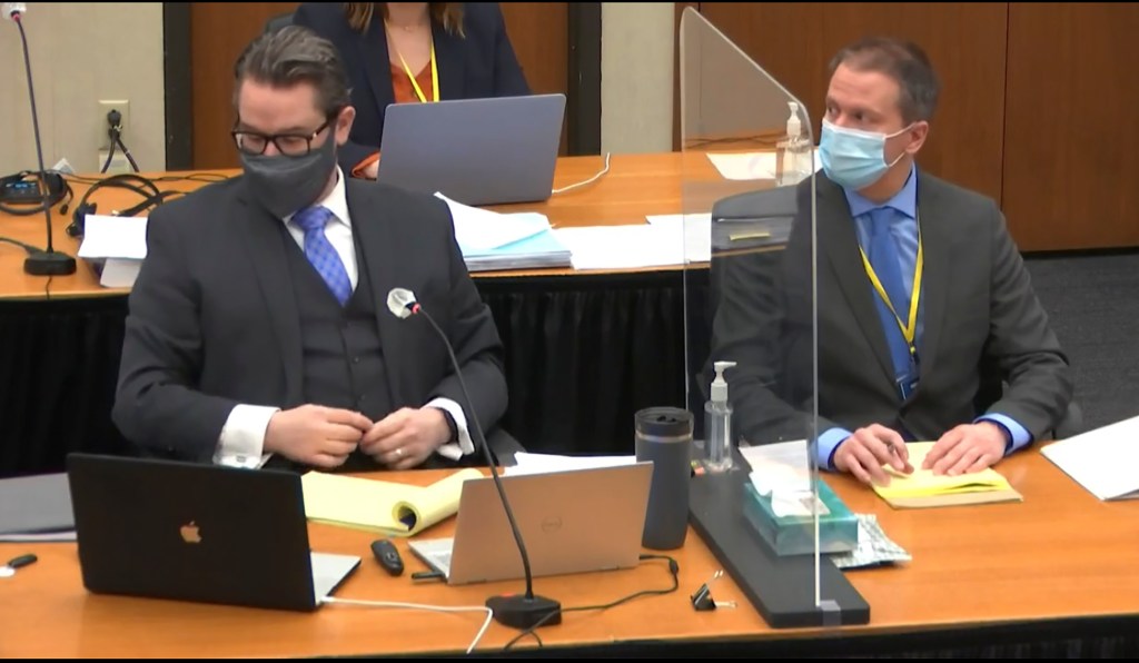 Defense attorney Eric Nelson, left, and defendant, former Minneapolis police officer Derek Chauvin, right, listen, Wednesday, April 14, 2021, in the trial of Chauvin at the Hennepin County Courthouse in Minneapolis.