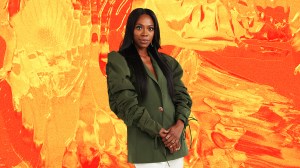 The actress Yvonne Orji against a yellow and orange background