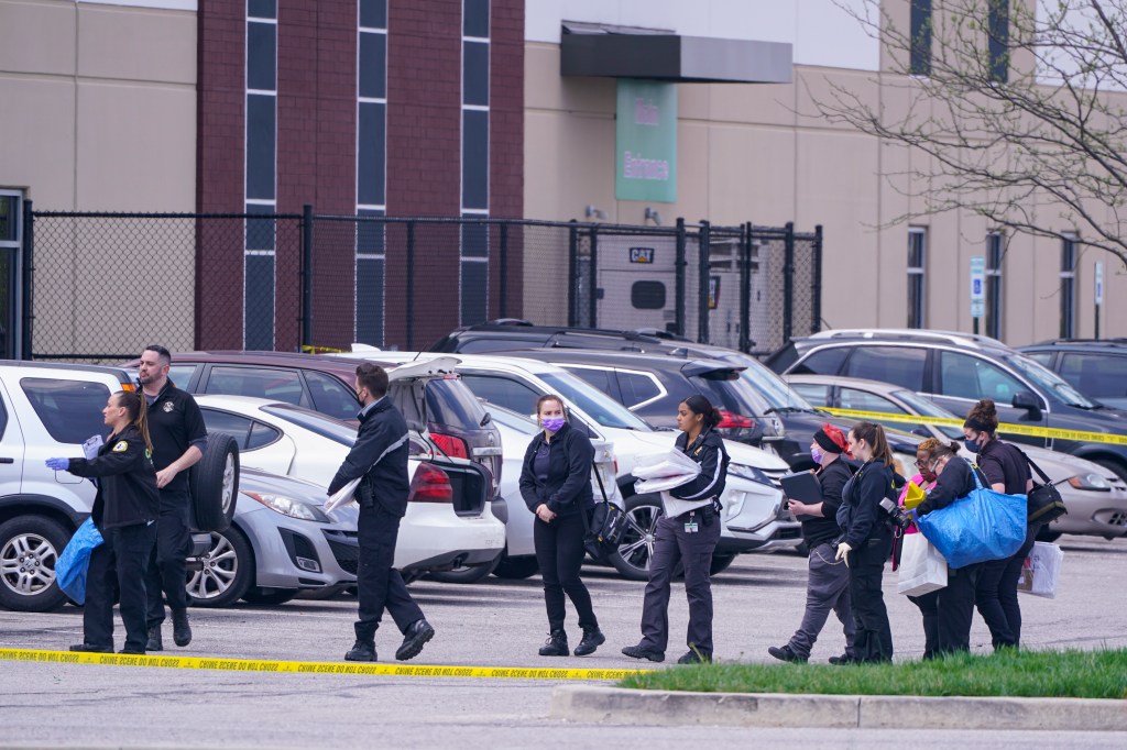 Law enforcement confer at the scene, Friday, April 16, 2021, in Indianapolis, where multiple people were shot at a FedEx Ground facility near the Indianapolis airport.