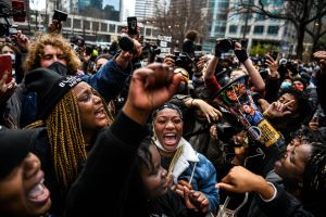 People celebrate as the verdict is announced in the trial of former police officer Derek Chauvin outside the Hennepin County Government Center in Minneapolis, Minnesota on April 20, 2021.