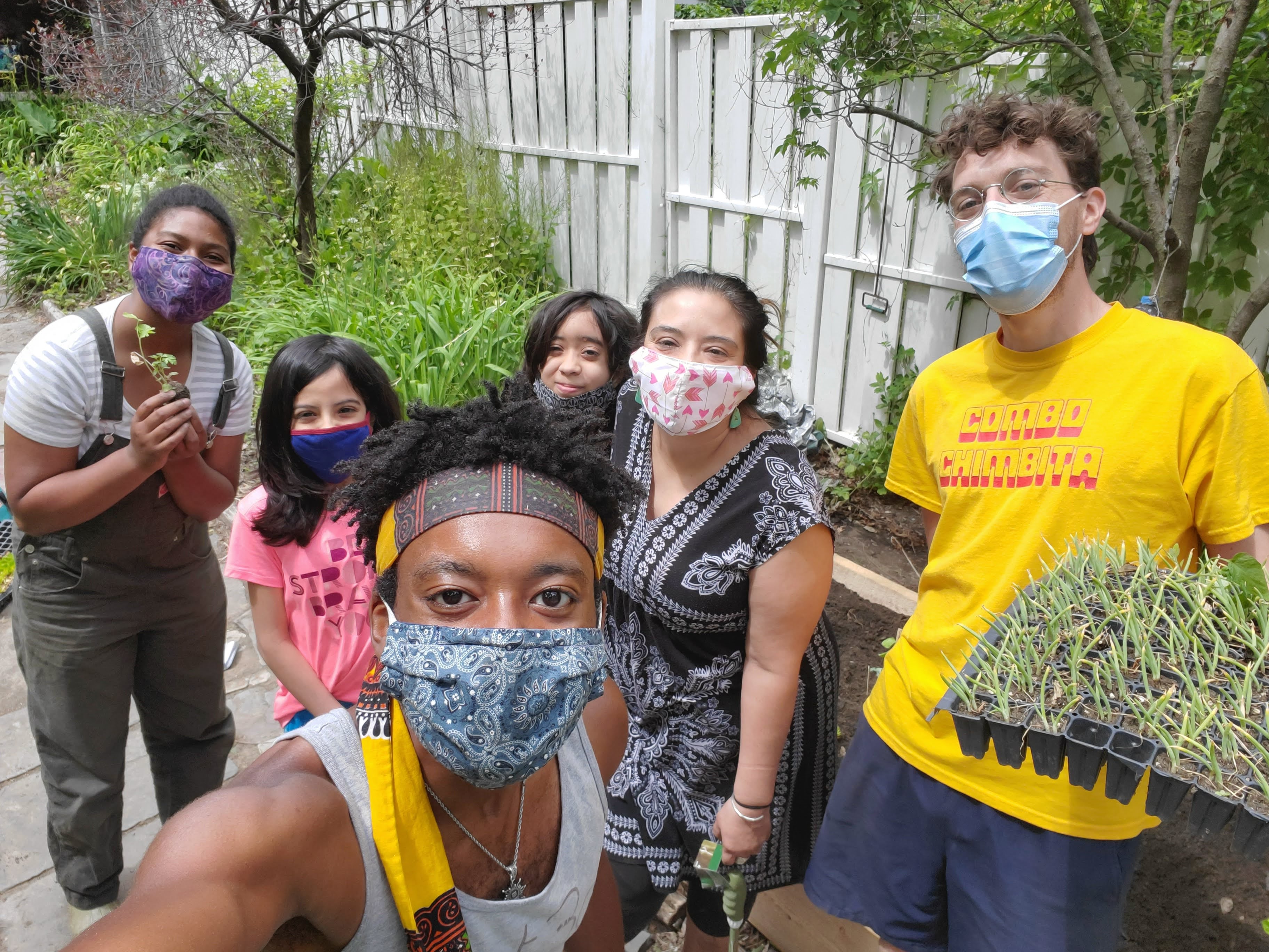 People at Soul Fire Farm pose for a photo with plants