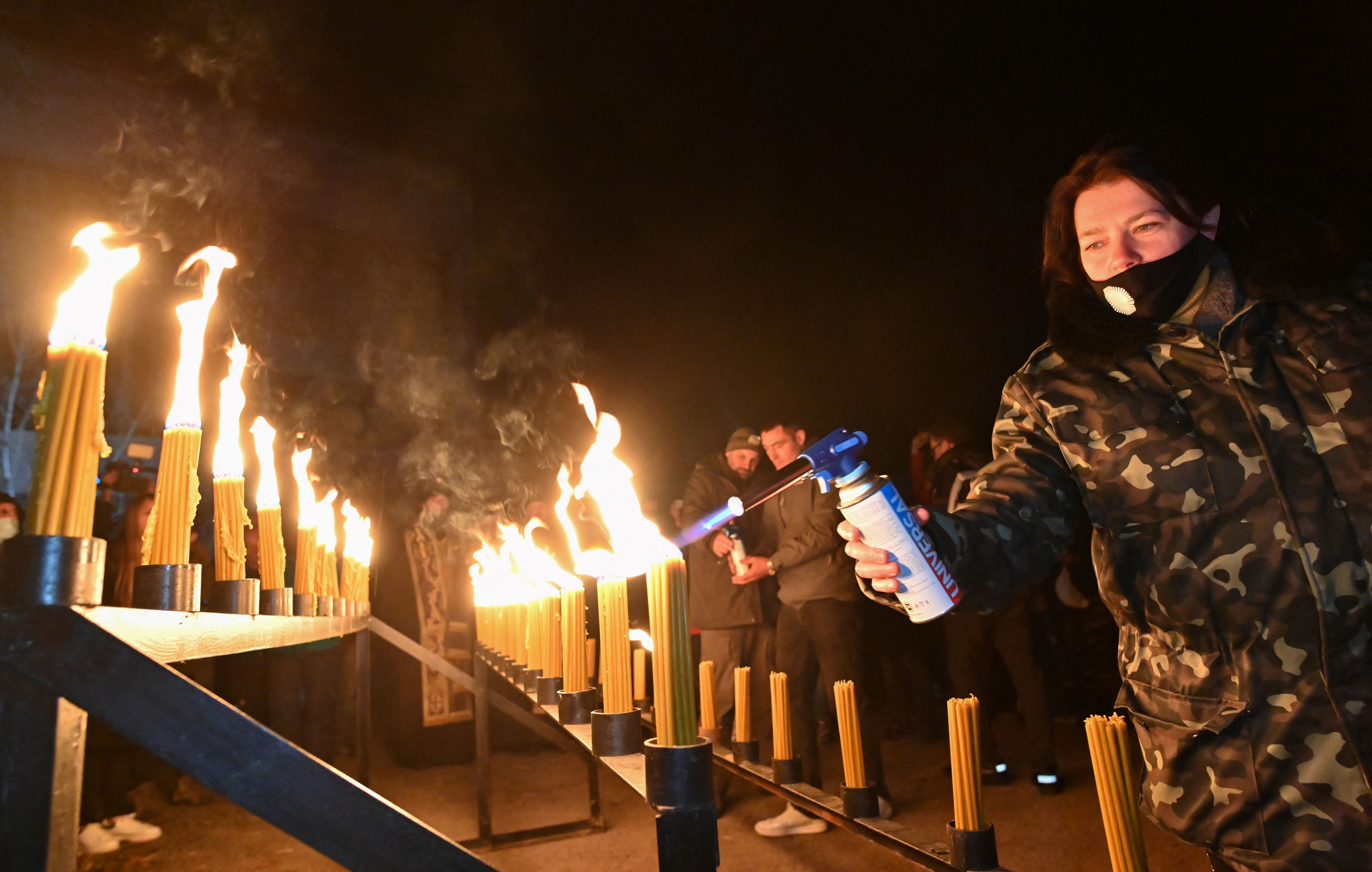 People light candles on the central square of the ghost town of Pripyat near the Chernobyl Nuclear Power Plant on early April 26, 2021, to commemorate the 35th anniversary of the Chernobyl nuclear disaster. Photo: Genya SAVILOV / AFP