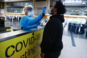 A man receives a nasal swab COVID-19 test at Tom Bradley International Terminal at Los Angeles International Airport (LAX) amid a coronavirus surge in Southern California on December 22, 2020 in Los Angeles, California.