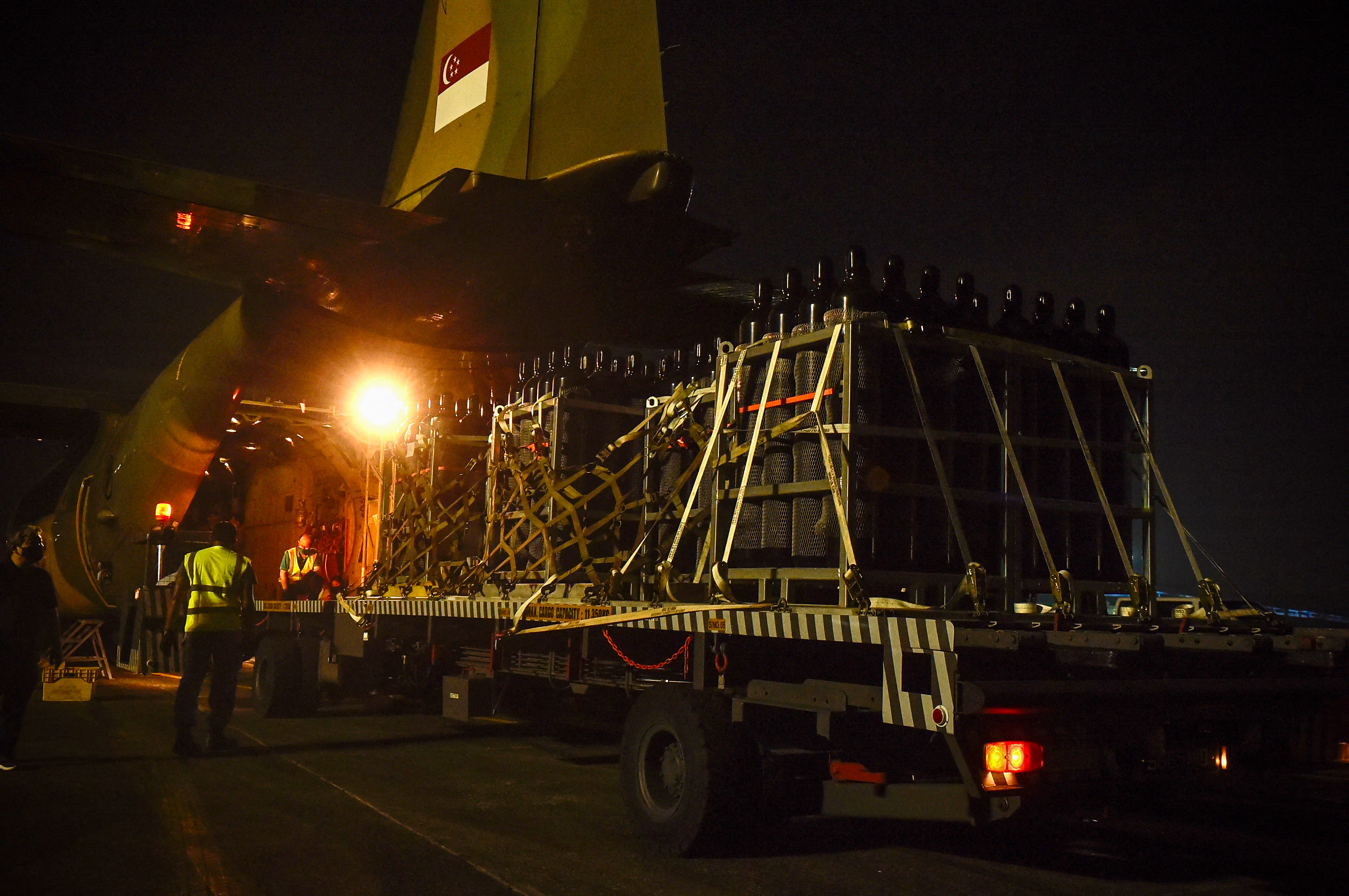 A consignment of oxygen cylinders being loaded onto a Singapore aircraft to be sent to West Bengal. PHOTO: MINISTRY OF DEFENCE SINGAPORE / AFP