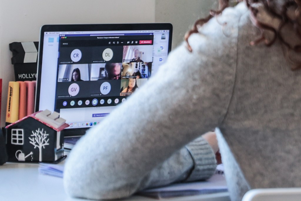 A student attends a Zoom conference on their laptop.