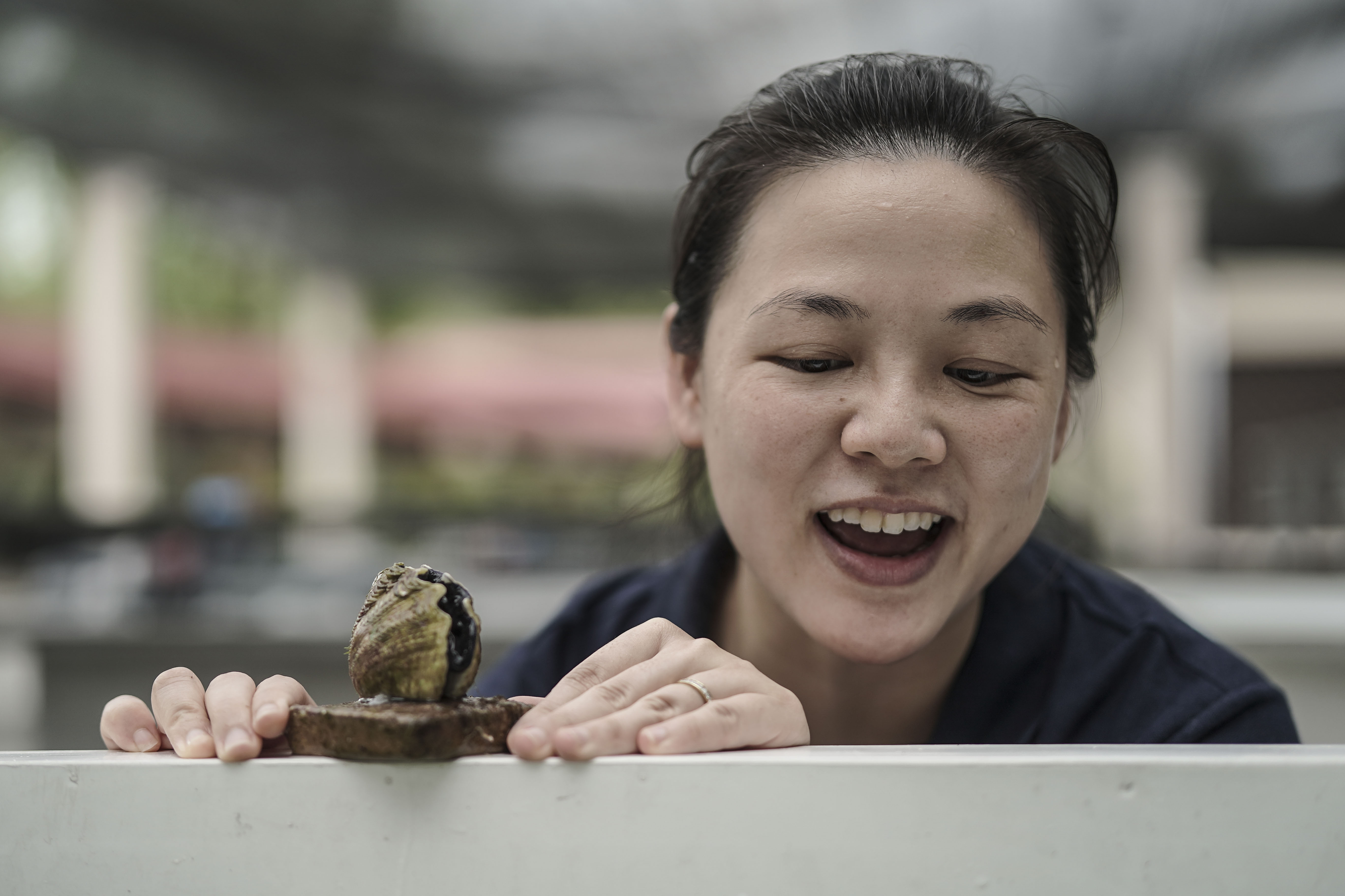 Neo Mei Lin is known for her work reviving giant clams. Here she is with a local specimen. PHOTO: WALLACE WOON