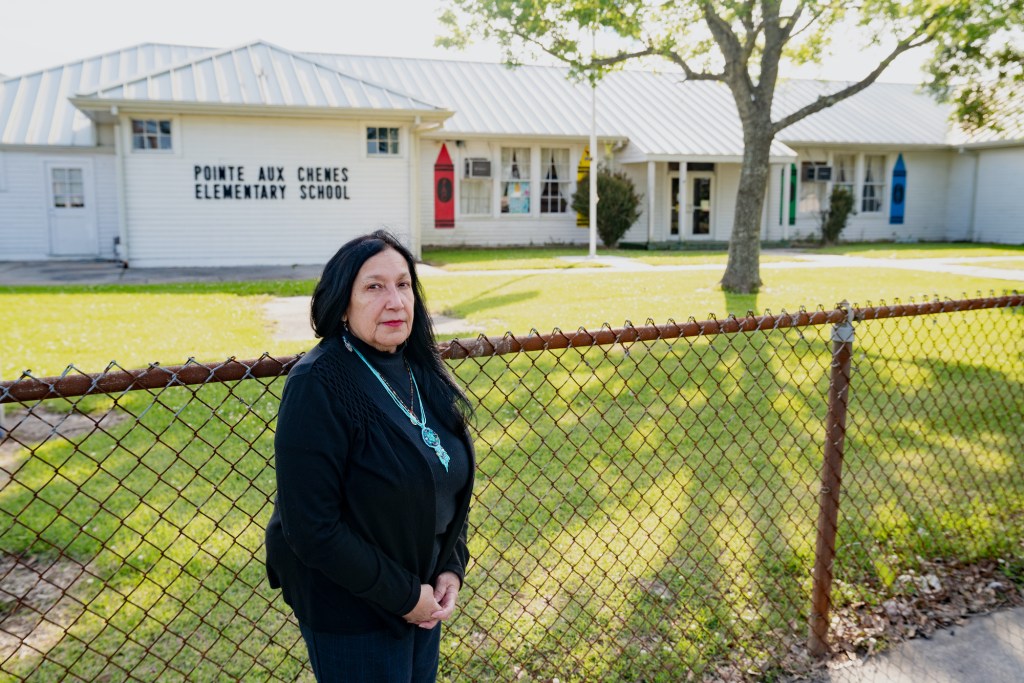 Theresa Dardar of the Pointe-au-Chien tribe stands in front of  Pointe-Aux-Chênes Elementary, which she is fighting to keep open. All photos by Avery White