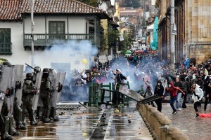 Protesters clash with riot police officers at Bolivar square during protests against the tax reform proposed by President Duque on April 28, 2021 in Bogota, Colombia. The death toll from the protests has risen to around 24.