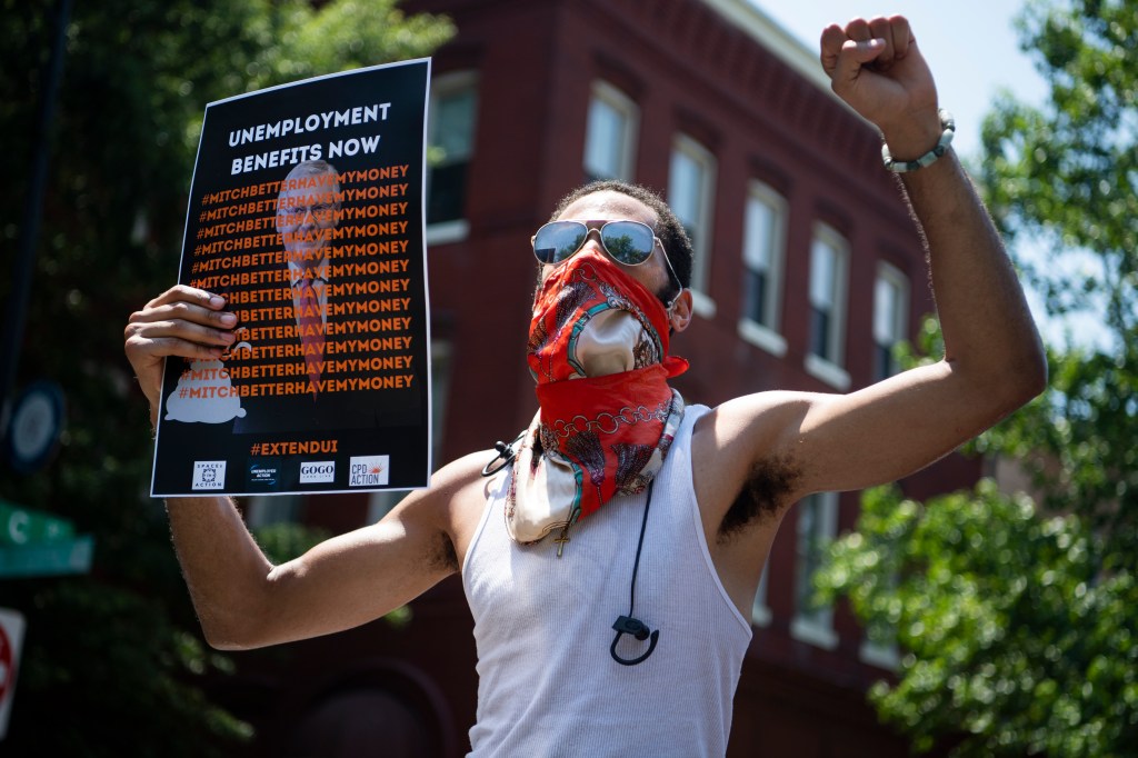 Demonstrators rally near the Capitol Hill residence of Senate Majority Leader Mitch McConnell, R-Ky., to call for the extension of unemployment benefits on Wednesday, July 22, 2020. The benefit, created by the CARES Act, is set to expire on July 31.