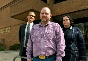 Randall Menges, front, along with his attorneys Matthew Strugar and Elizabeth Ehret, pause outside the Russell Smith Federal Courthouse in March, 2021, in Missoula, Mont. (Tom Bauer/The Missoulian via AP)