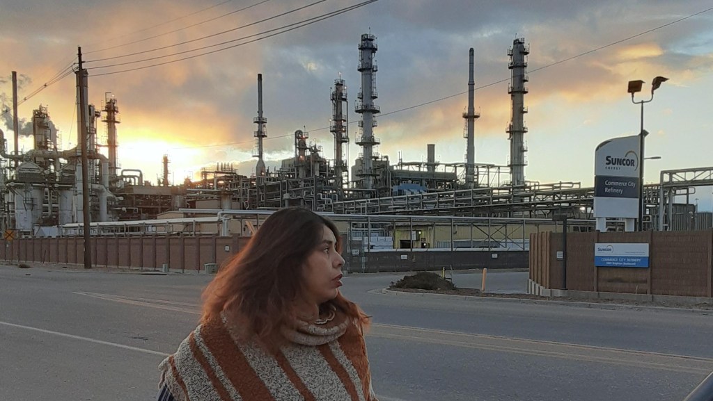 ​Lucy Molina in front of Suncor's Commerce City refinery in Colorado