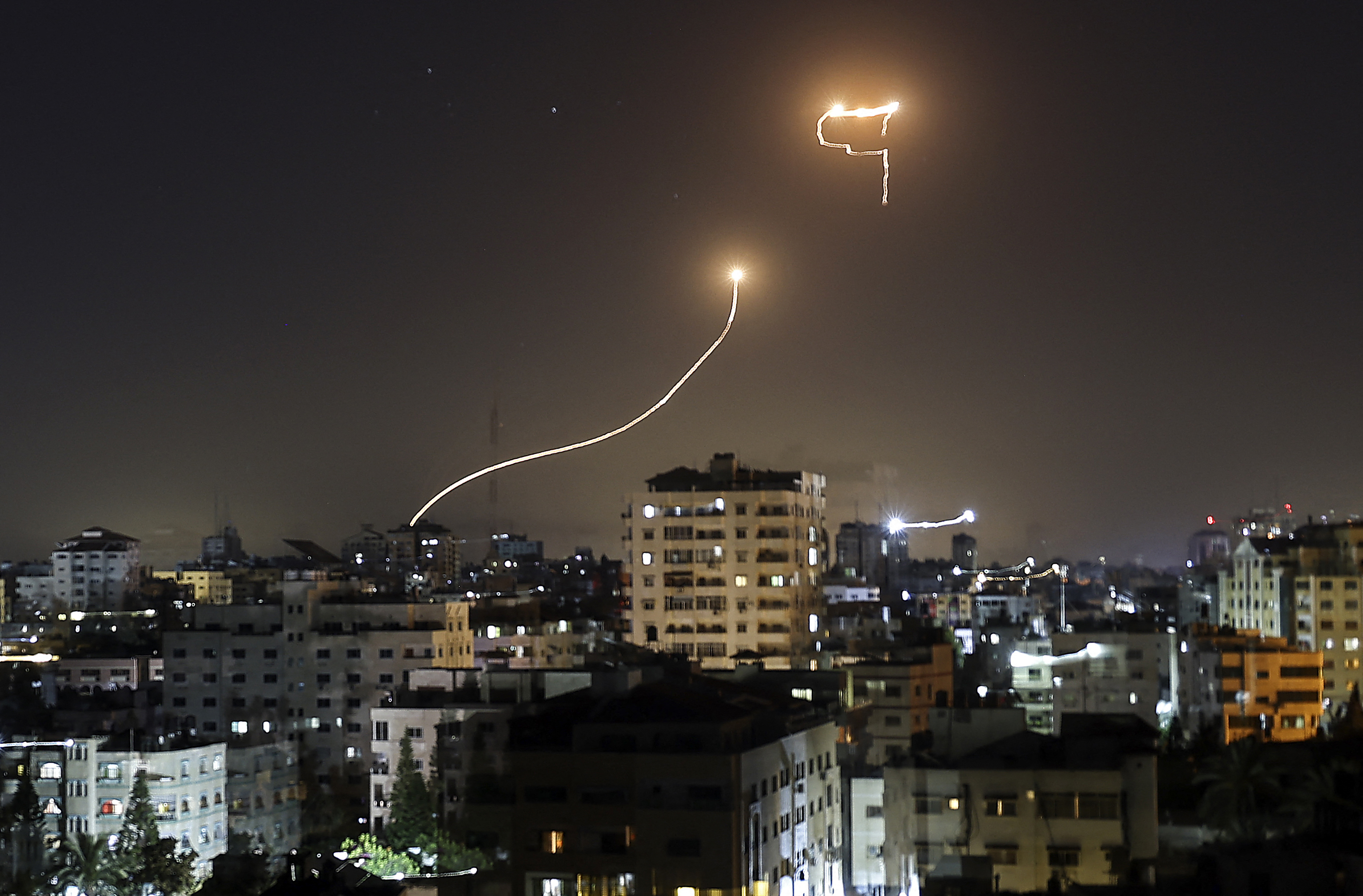 A streak of light appears as Israel’s Iron Dome anti-missile system intercepts rockets fired by Palestinian militants from the Gaza Strip. Photo: MAHMUD HAMS/AFP via Getty Images