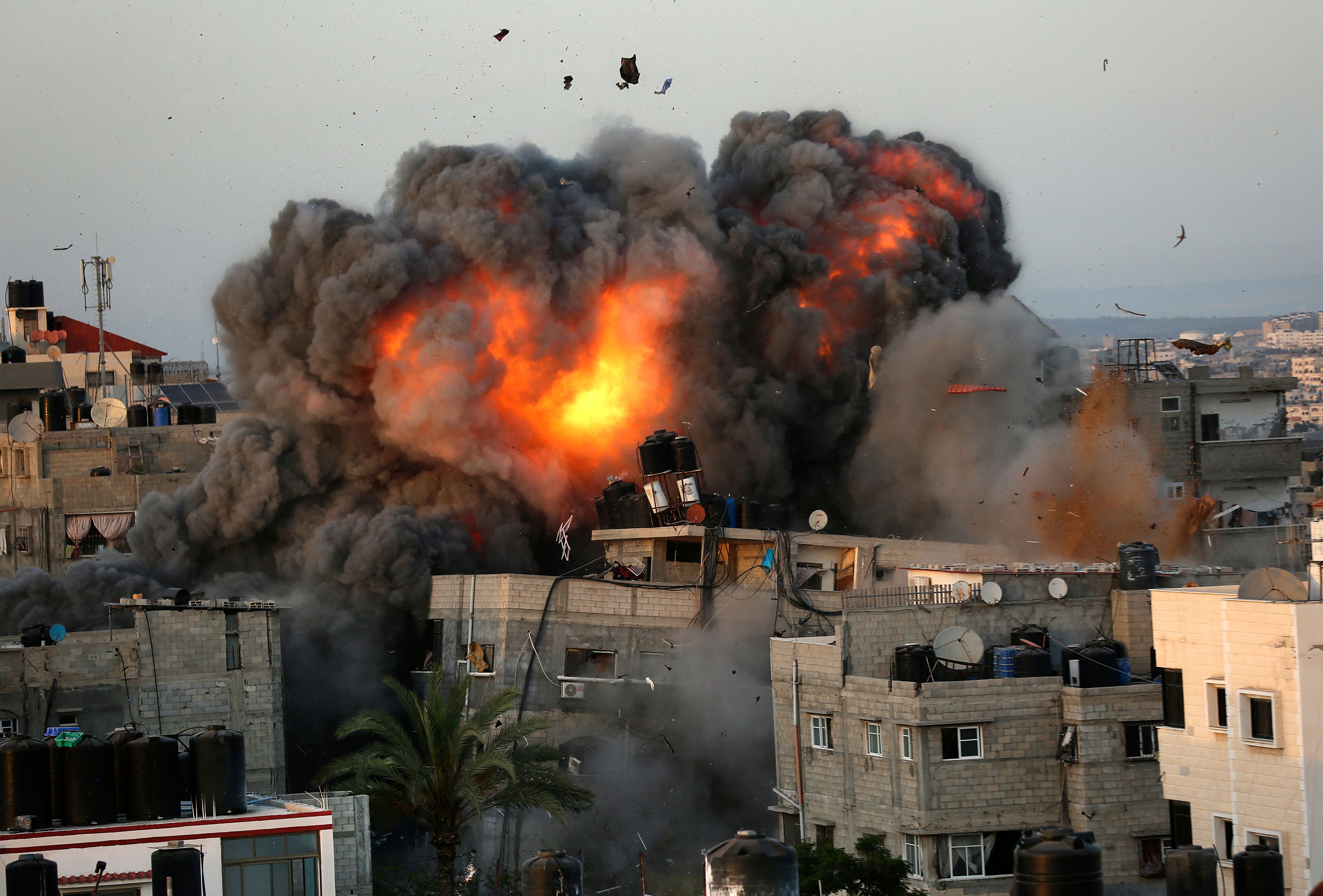 A fireball erupts from a building in Gaza City following an Israeli airstrike. Photo: BASHAR TALEB/AFP via Getty Images