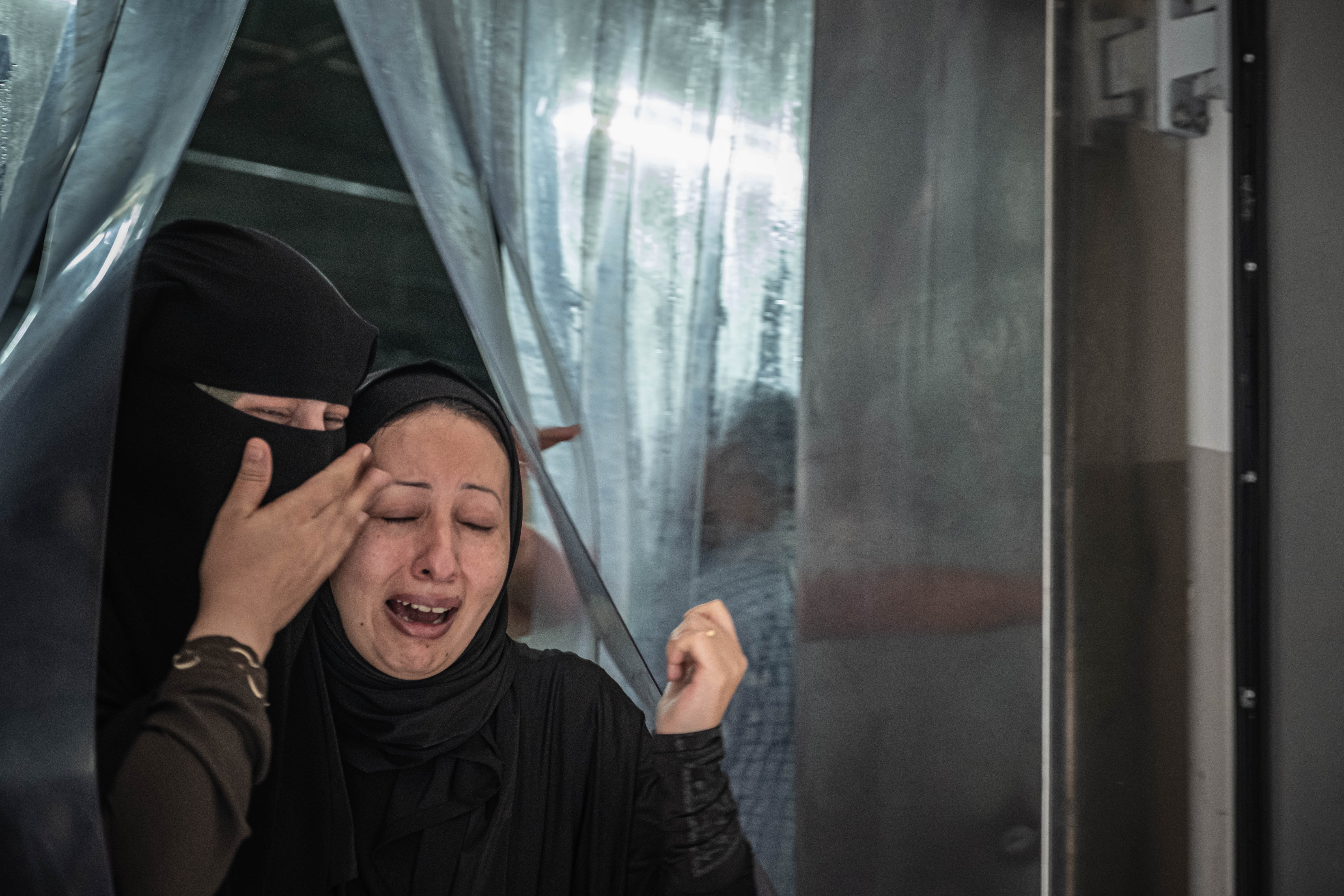 Women mourn for relatives killed in an Israeli air raid after inspecting their bodies at a hospital in Gaza City. Photo:Fatima Shbair/Getty Images