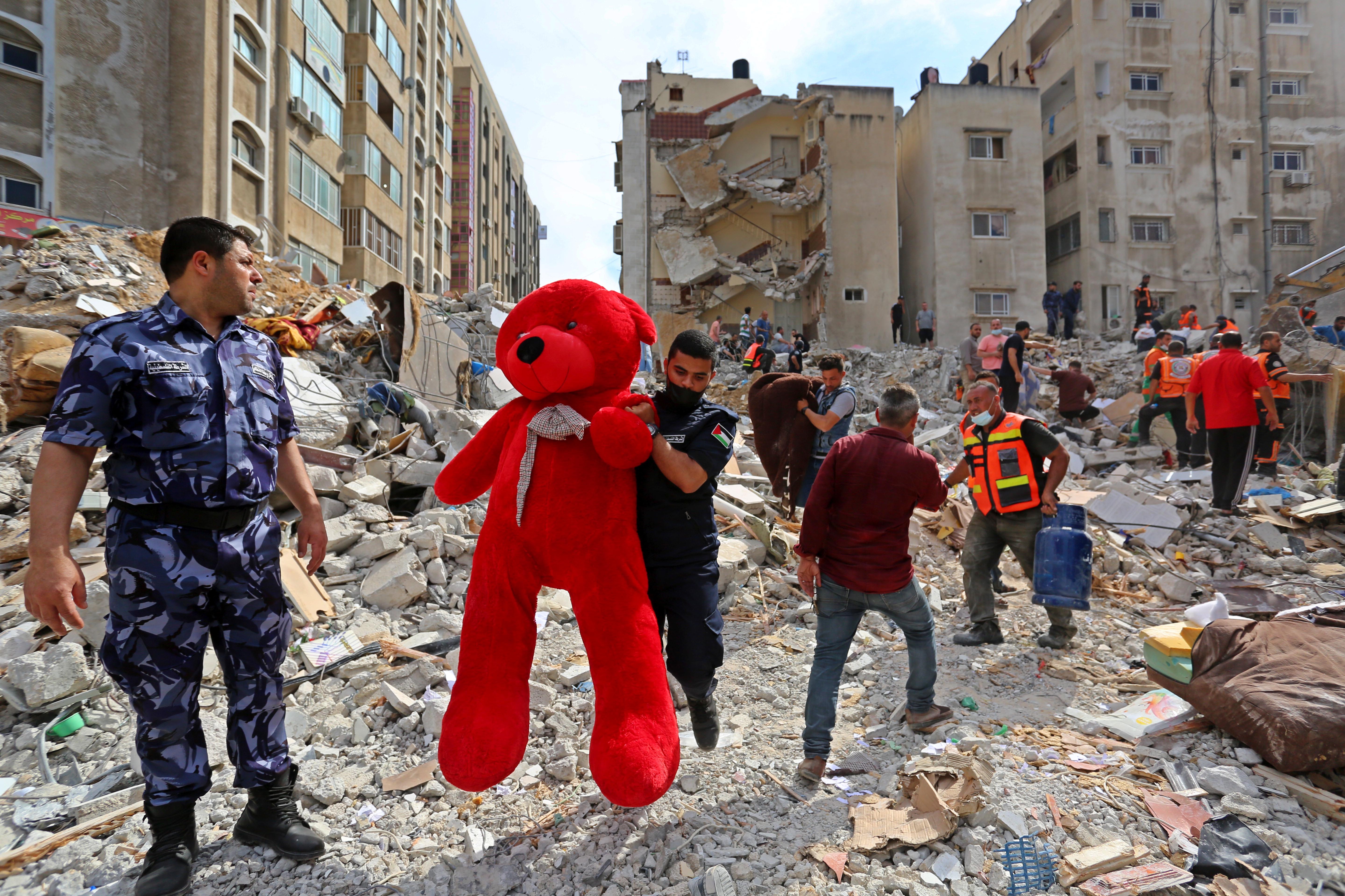 A teddy bear is removed from debris as search and rescue workers look for survivors following an Israeli airstrike. Photo: Ashraf Amra/Anadolu Agency via Getty Images