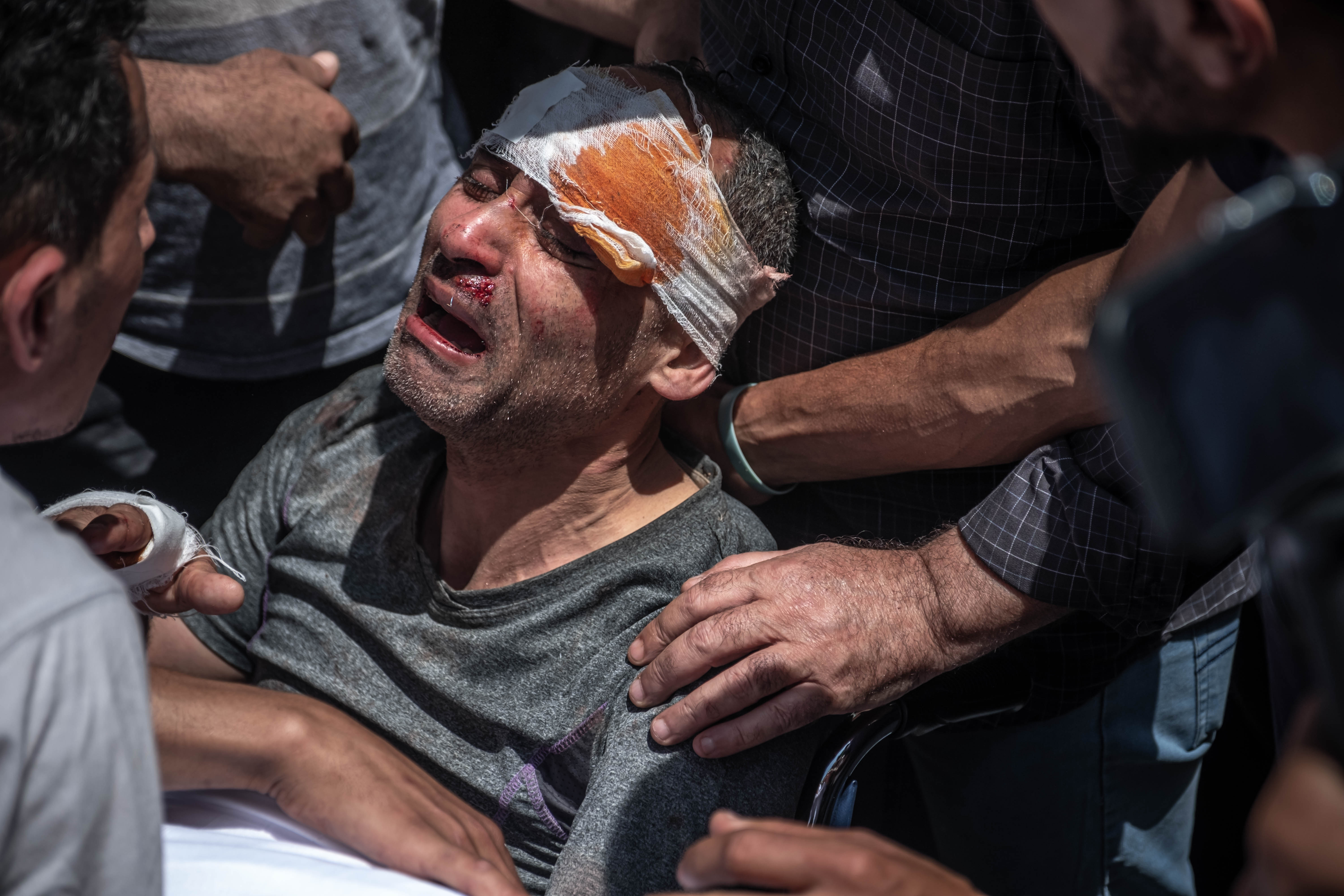 A Palestinian survivor of an Israeli airstrike mourns his children, who did not survive. Photo: Fatima Shbair/Getty Images