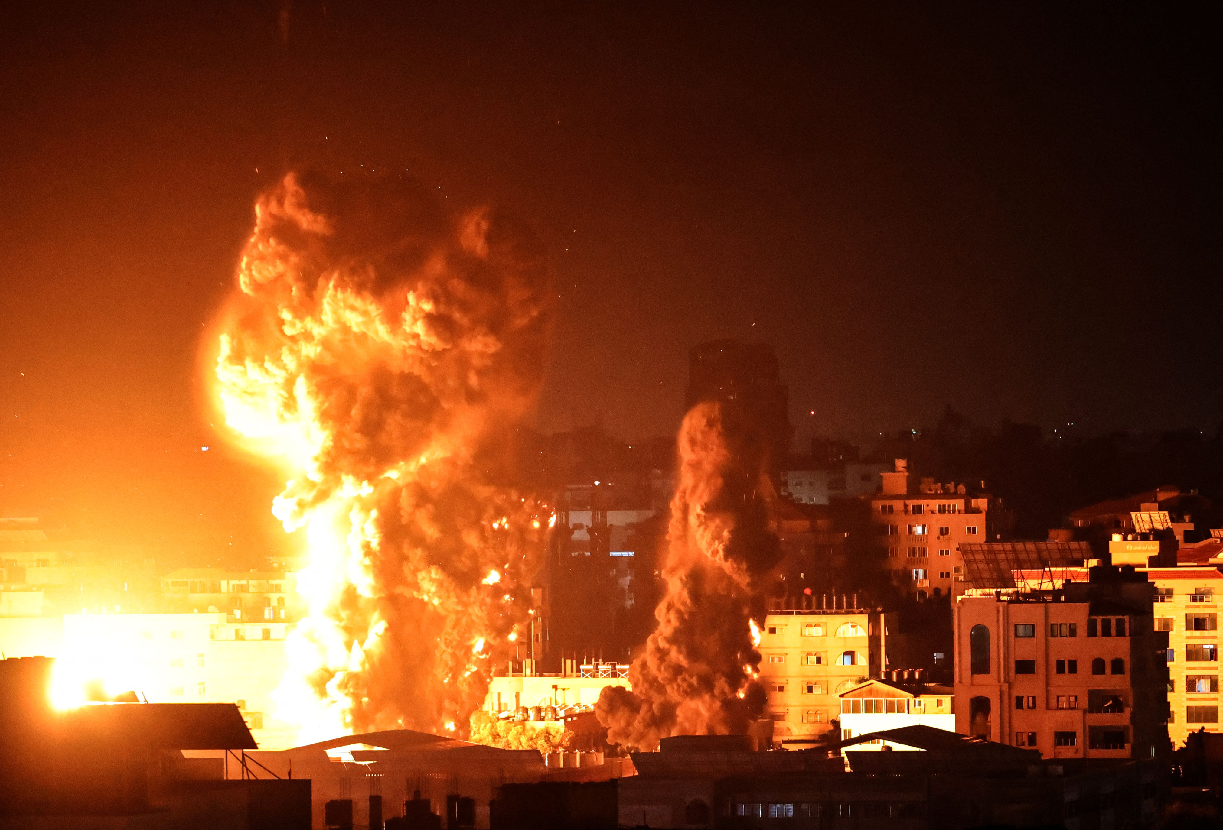 Fire and smoke rises above a building struck by an Israeli airstrike in the early hours of Monday morning. Photo: ANAS BABA/AFP via Getty Images