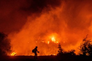 A firefighter battles the Bond Fire burning in the Silverado community in Orange County, Calif., early Thursday, Dec. 3, 2020.