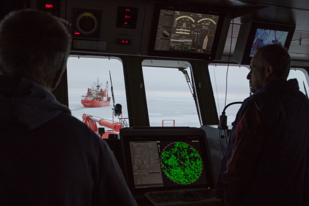 two men looking out of the ship