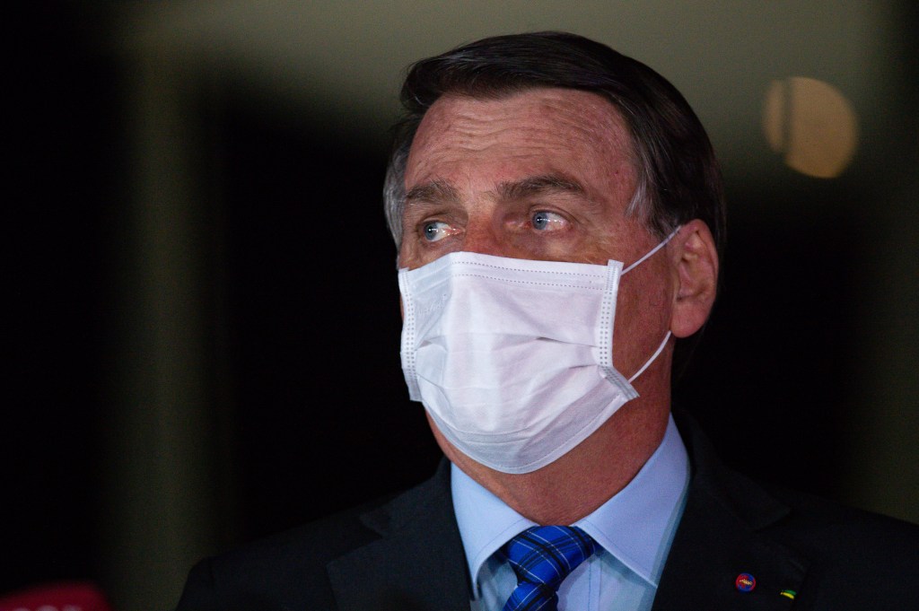 Brazilian President Jair Bolsonaro wearing a white surgical mask.