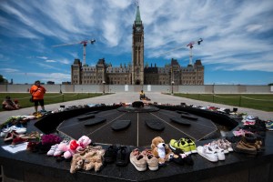 Parliament hill with shoes in memory of students from Indian Residential School at Tk’emlups te Secwépemc First Nation