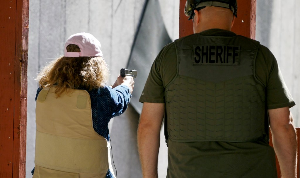 In this Saturday, June 29, 2019, photo, a school staff member participates in shooting drills at the Utah County Sheriff's Office shooting range during training, in Spanish Fork Canyon, Utah.