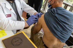 Member of the Metropolitan Drug Enforcement Network Team receives the vaccine in Riggleman Hall on the campus of the University of Charleston, West Virginia.