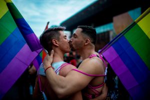 Men kiss as they take part in the Gay Pride Parade in Santiago on June 22, 2019.