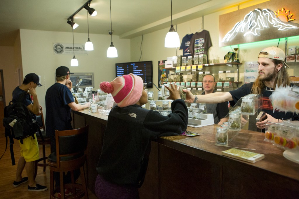 An employee advises a client on one of the more than twenty strands available at A Greener Today, a popular cannabis store in Seattle, on March 14, 2014 in Seattle, Washington.