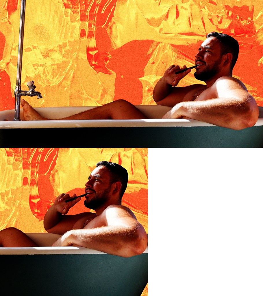 John Paul Brammer in a tub against an orange and gold background