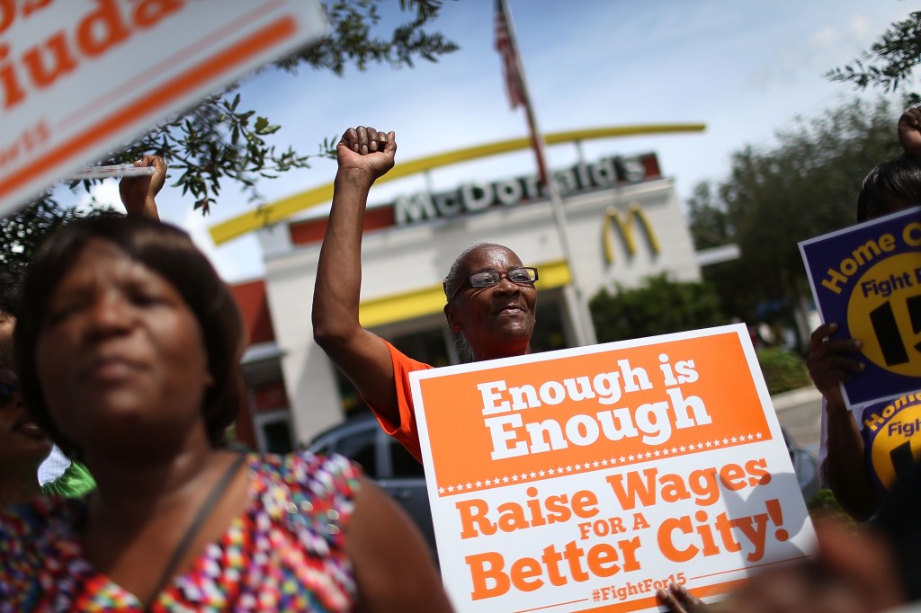 Laura Rollins joins with others to protest in front of a McDonald's restaurant in support of a $15 an hour minimum wage on September 10, 2015 in Fort Lauderdale, Florida. (Joe Raedle/Getty Images)