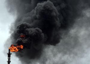 Thick black smoke and flame billows from a Nigerian gas refinery.