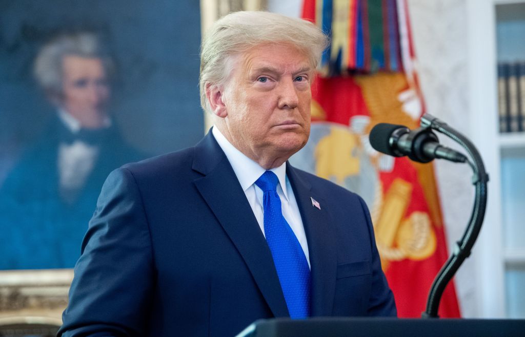 TOPSHOT - US President Donald Trump looks on during a ceremony presenting the Presidential Medal of Freedom to wrestler Dan Gable in the Oval Office of the White House in Washington, DC on December 7, 2020. (Photo by SAUL LOEB / AFP) (Photo by SAUL LOEB/A