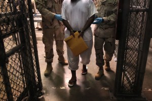 U.S. Navy guards escort a detainee at Camp 6 in the Guantanamo Bay detention center on March 30, 2010 in Guantanamo Bay, Cuba.