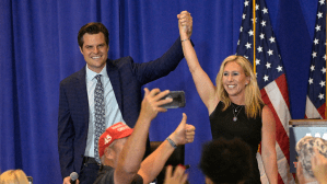 Rep. Matt Gaetz, R-Fla., left, and Rep. Marjorie Taylor Greene, R-Ga., raise their arms after addressing attendees of a rally, Friday, May 7, 2021, in The Villages, Fla.