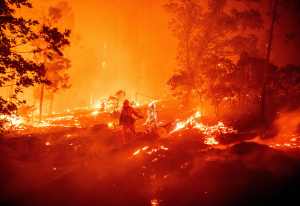 A firefighter works the scene as flames push towards homes during the Creek fire in the Cascadel Woods area of unincorporated Madera County, California on September 7, 2020.