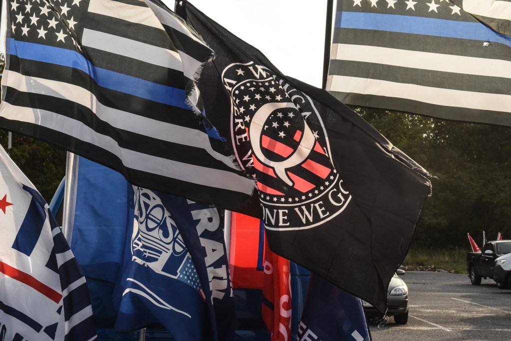 A flag for the QAnon conspiracy theory is flown with other right wing flags during a pro-Trump rally on October 11, 2020 in Ronkonkoma, New York (Stephanie Keith/Getty Images)